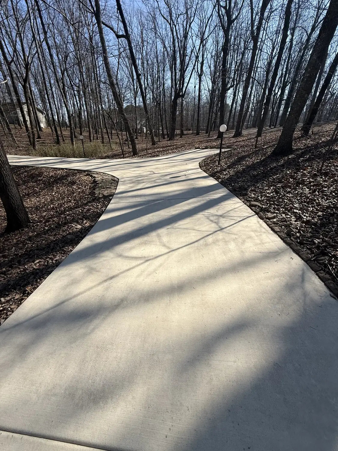 Freshly pressure washed concrete walkway at a North Alabama home