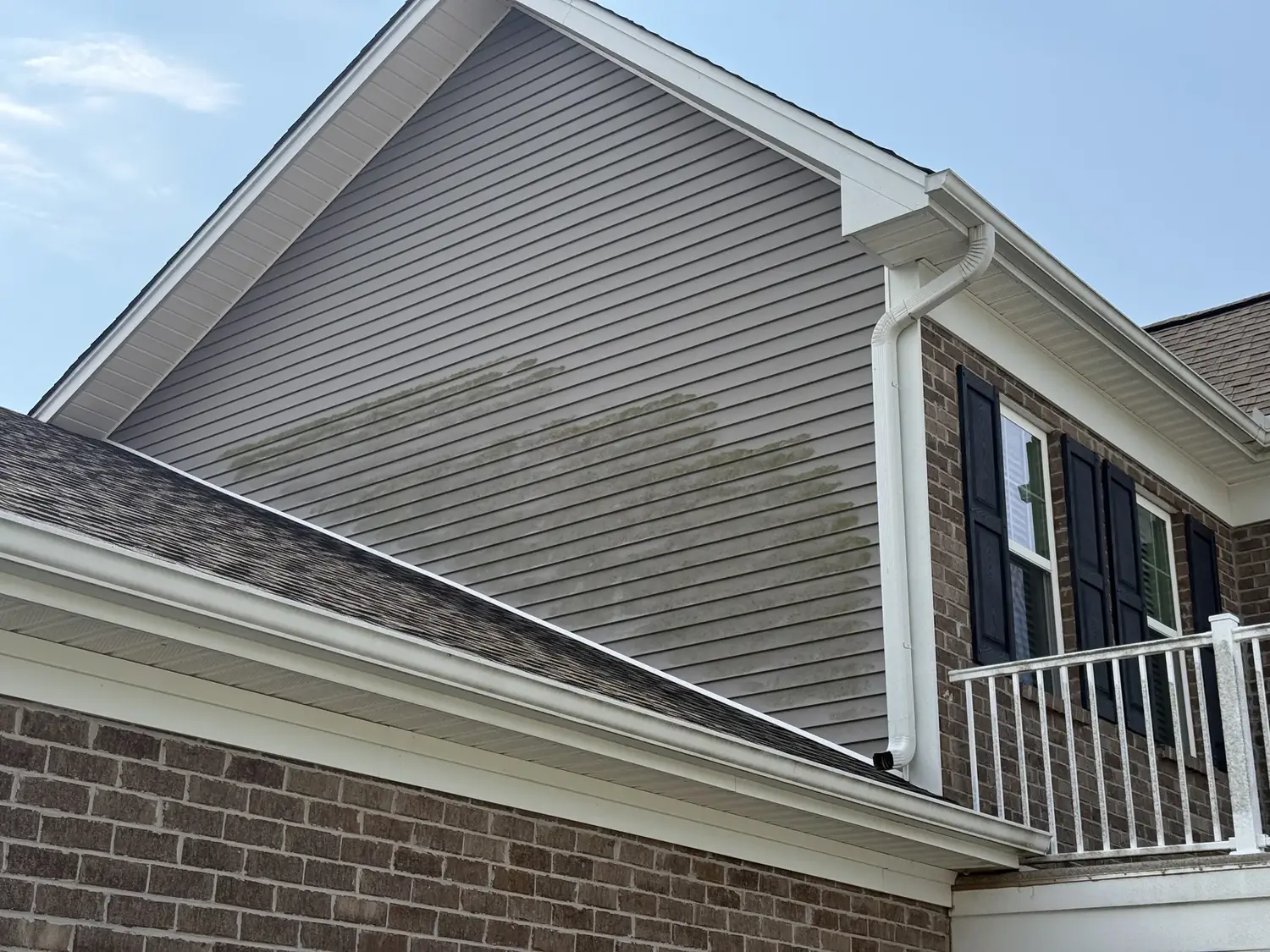 Clean second-story siding and gable after house washing