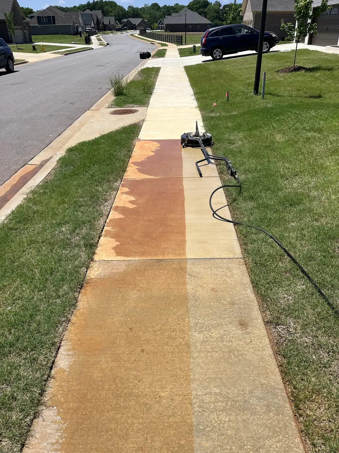 Sidewalk pressure washing with a clear clean section