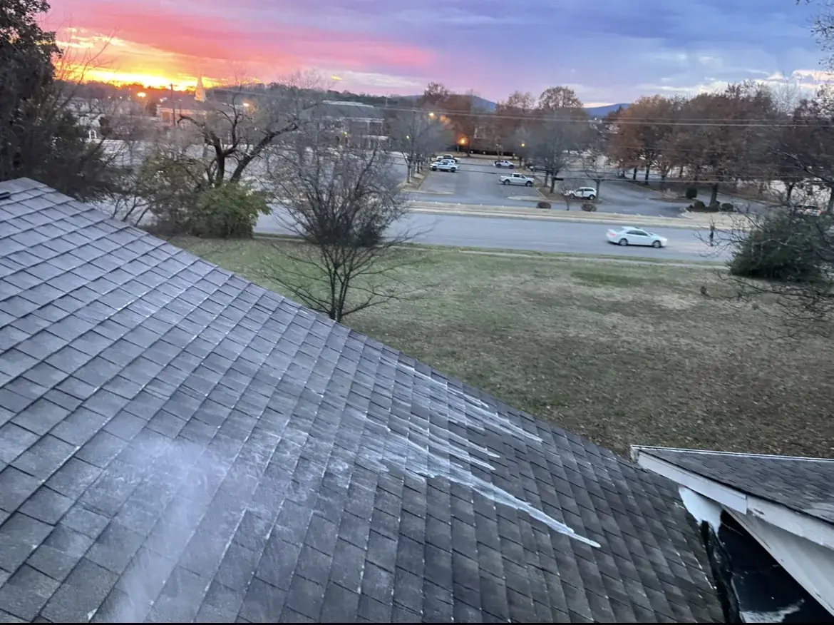 Roof soft wash application on black-streaked asphalt shingles