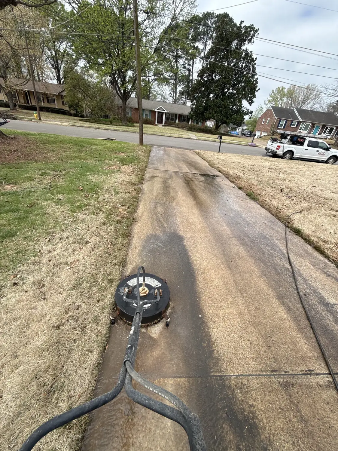 Driveway pressure washing in progress